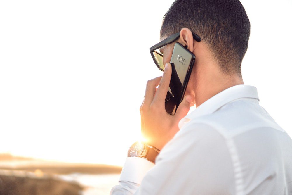 man speaking to people on the mobile