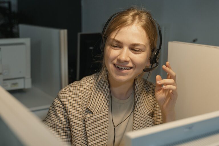 Image of a smiling agent in an outsourced inbound call center providing amazing customer service