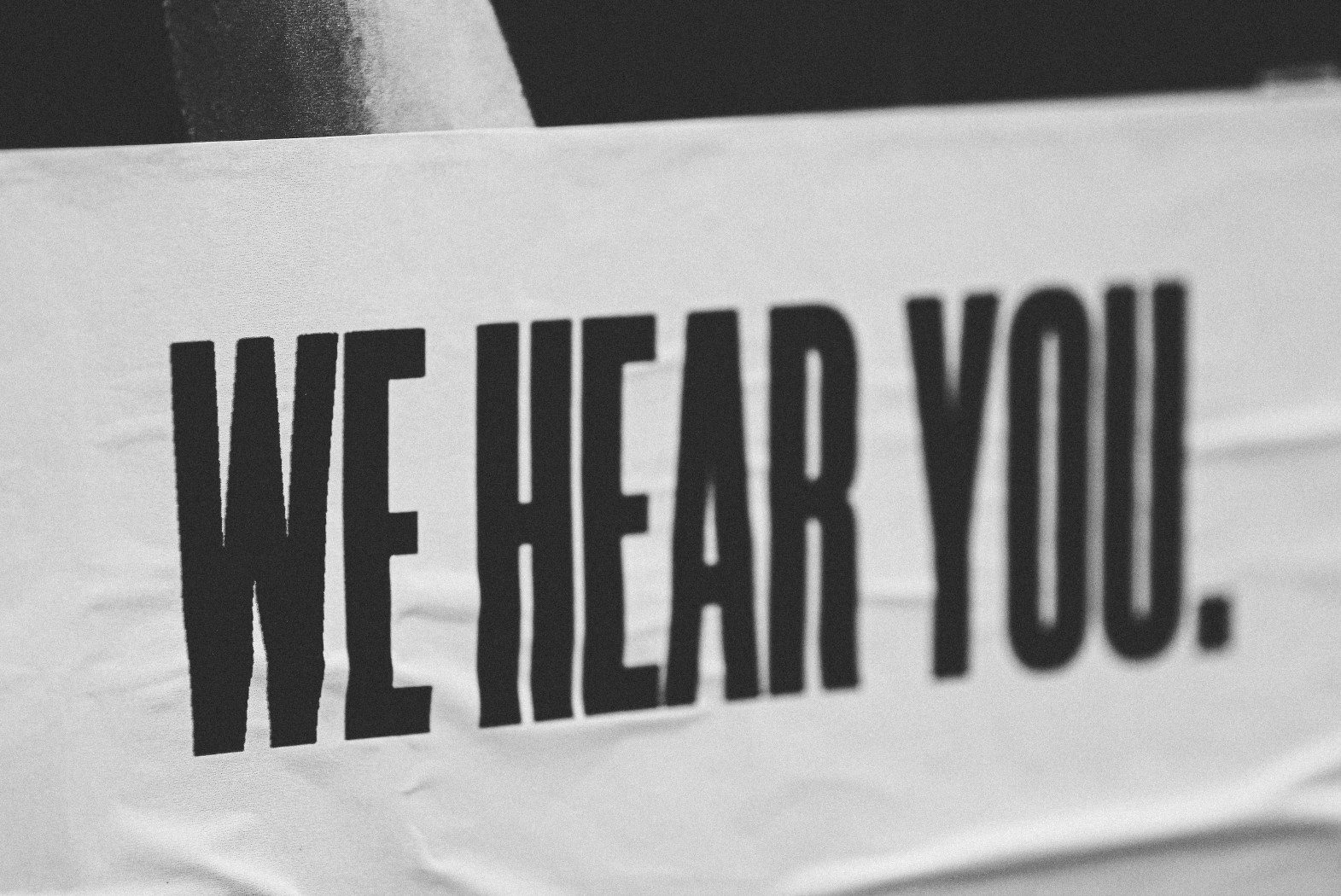 image of a sign that says "we hear you" from a patient satisfaction survey conducted by a call center for healthcare