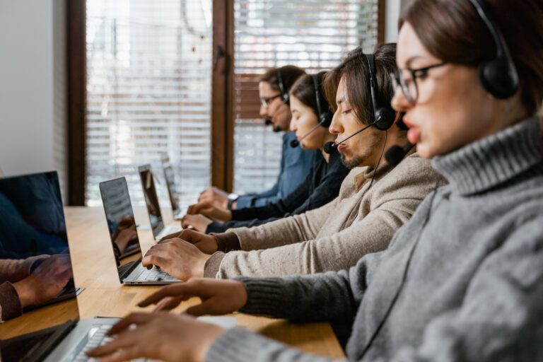 image of people at the computer as a virtual answering service for small business