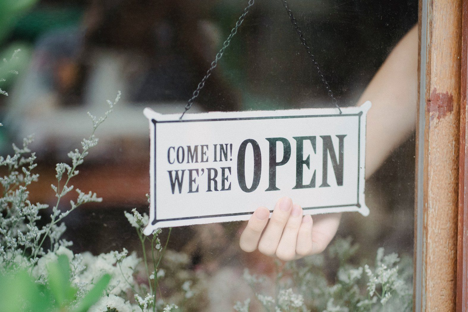 image of a we're open sign indicating 24 hour customer support